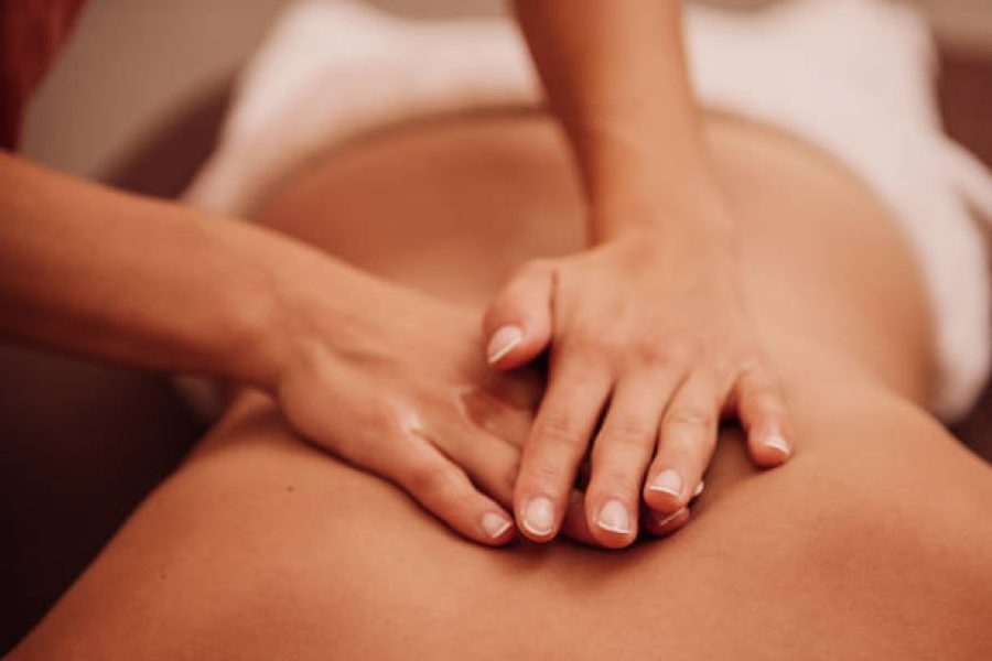 woman getting a back massage at a spa Photo taken indoors with stobe light